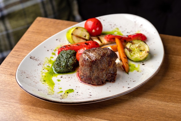 Grilled beef tenderloin steak Filet mignon with grilled vegetables and pesto sauce