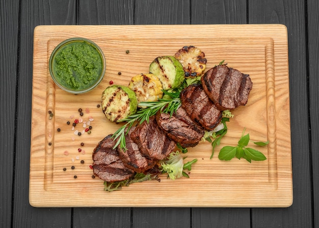 Grilled beefsteaks on cutting board