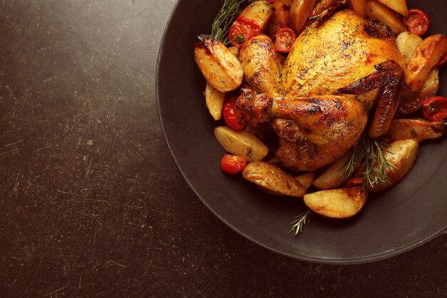 Grilled beer can chicken in pan on table