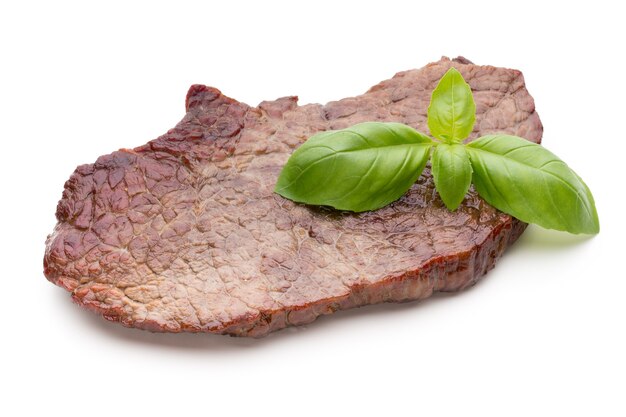 Grilled bio beef steaks with spices isolated on white background.