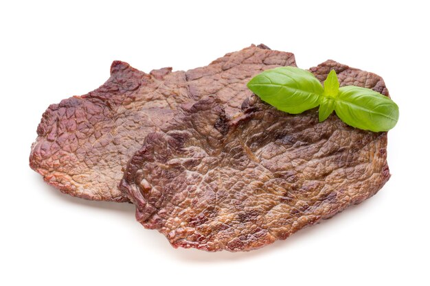 Grilled bio beef steaks with spices isolated on white.