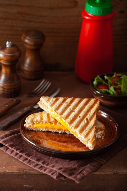 Grilled cheese sandwich on rustic brown background