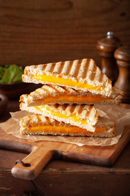 Grilled cheese sandwich on rustic brown background