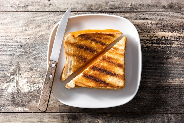 Grilled cheese sandwich on wooden table top view