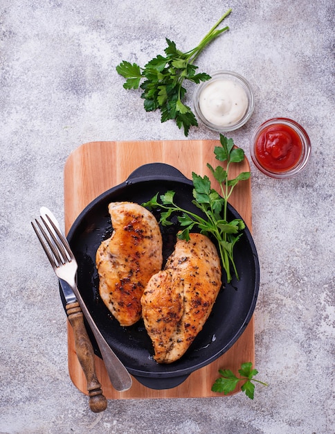 Grilled chicken breast or fillet on iron pan