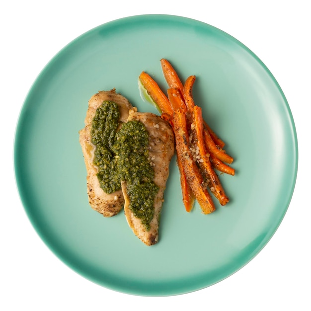 Grilled chicken breast herbs and carrots on a green plate isolated over white background