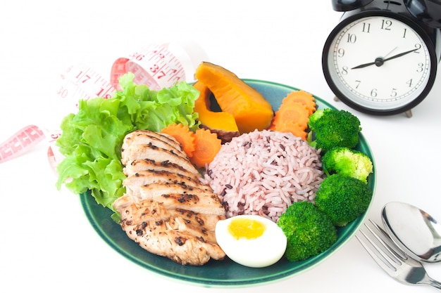 Grilled chicken breast, rice berry and vegetables on white background