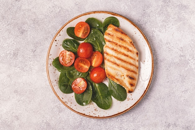 Grilled chicken breast served with vegetable salad