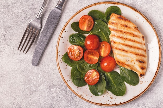 Grilled chicken breast served with vegetable salad