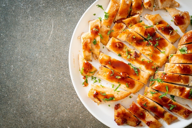 Grilled chicken breast sliced on plate