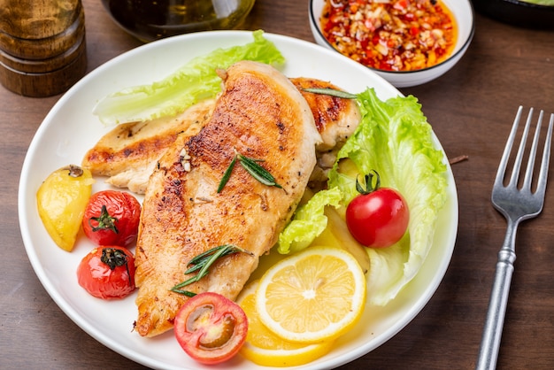 Grilled chicken breast and vegetable salad on the plate