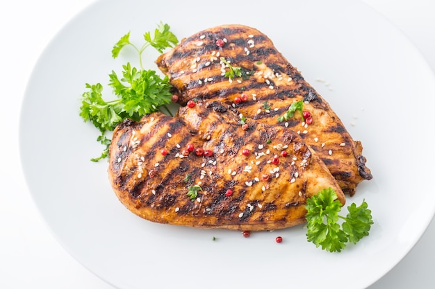 Grilled Chicken Breast with peppercorn parsley and seasame seeds isolated on white.