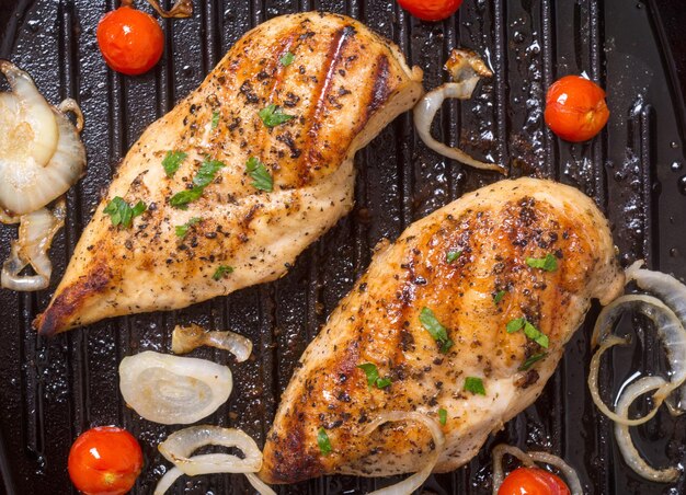 Grilled chicken breast with tomato parsley and onion