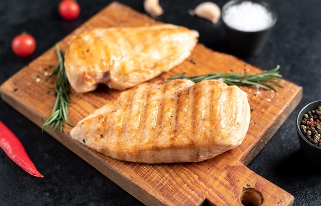 grilled chicken breasts on stone background