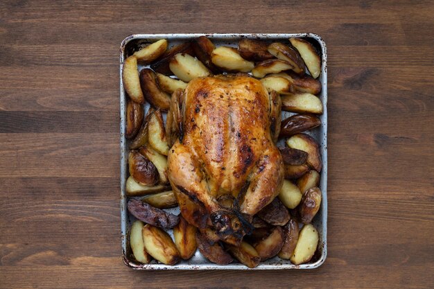 Grilled chicken close-up on a wooden table, top view