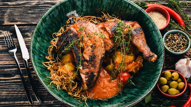 Grilled chicken cooked in a hoster Meat Top view On a black wooden background Copy space