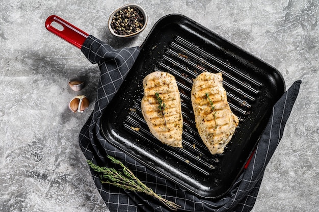 Grilled chicken fillet breasts on a cooking pan