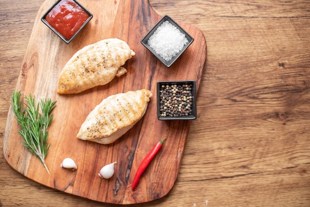 grilled chicken fillet on wooden background