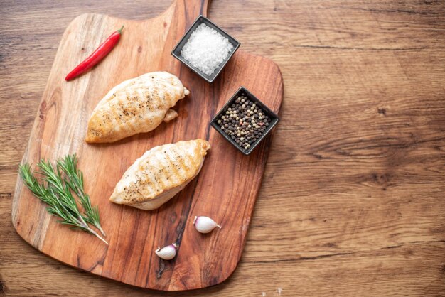 grilled chicken fillet on wooden