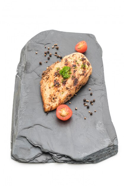 Grilled chicken fillets on slate plate