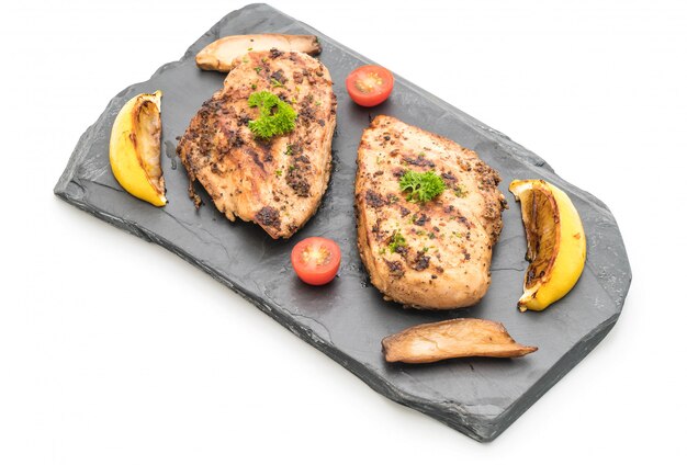 Grilled chicken fillets on slate plate