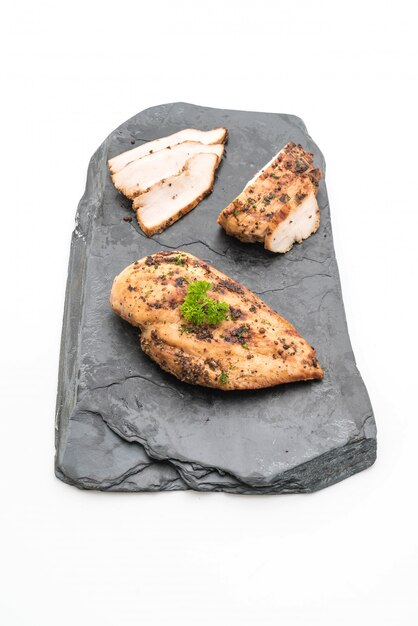 Grilled chicken fillets on slate plate