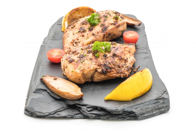 Grilled chicken fillets on slate plate