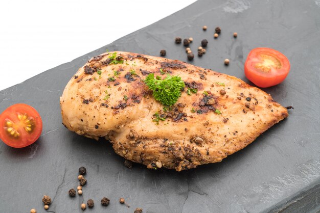 Grilled chicken fillets on slate plate