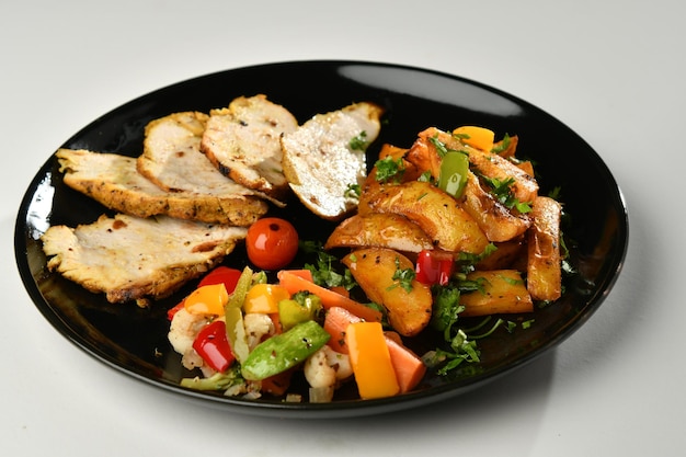 Grilled chicken . Fried chicken fillet and fresh vegetable salad of tomatoes,