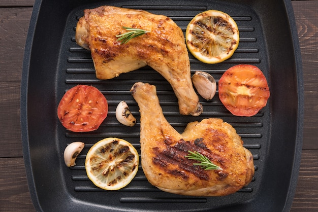 Grilled chicken lag and vegetables in a pan