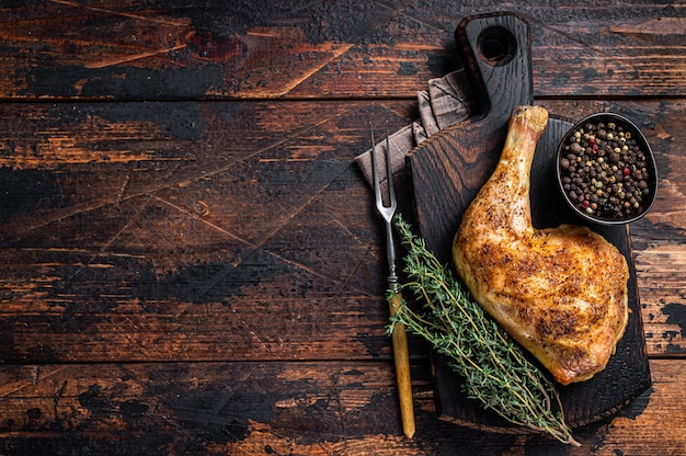 Grilled chicken leg on a wooden board