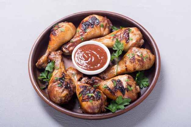 Grilled chicken legs with tomato sauce BBQ food background