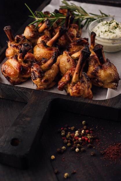 Grilled chicken legs on wooden tray