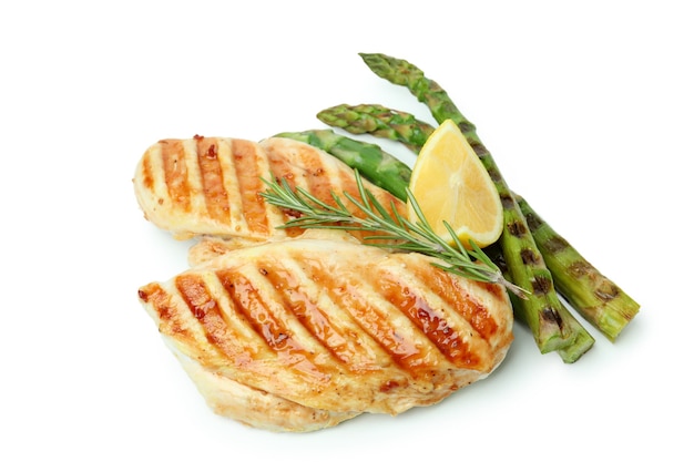 Grilled chicken meat, asparagus, rosemary and lemon isolated on white background