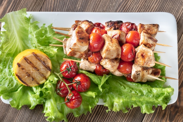 Grilled chicken skewers on the white plate