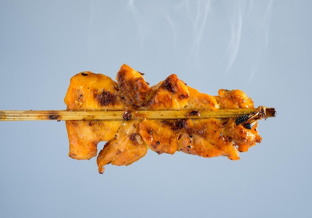 Grilled chicken skewers with smoke