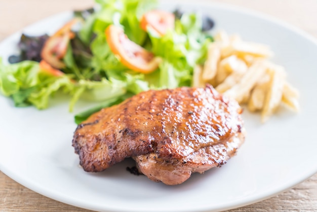 grilled chicken steak with french fries and vegetable salad