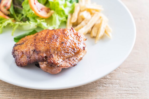 grilled chicken steak with french fries and vegetable salad