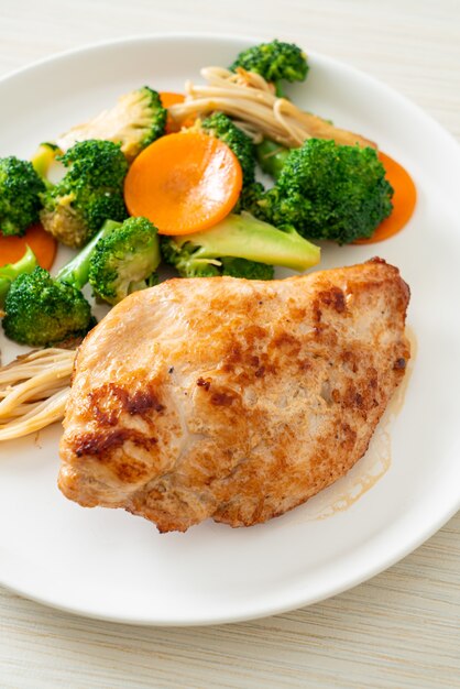 grilled chicken steak with vegetable on white plate