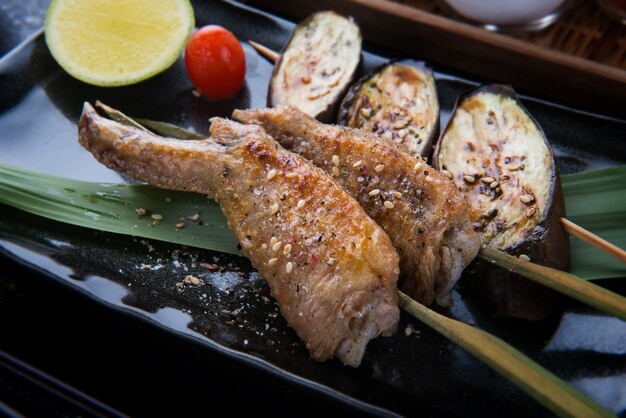 Grilled chicken wing with salt pepper seasoning with indoor lighting.