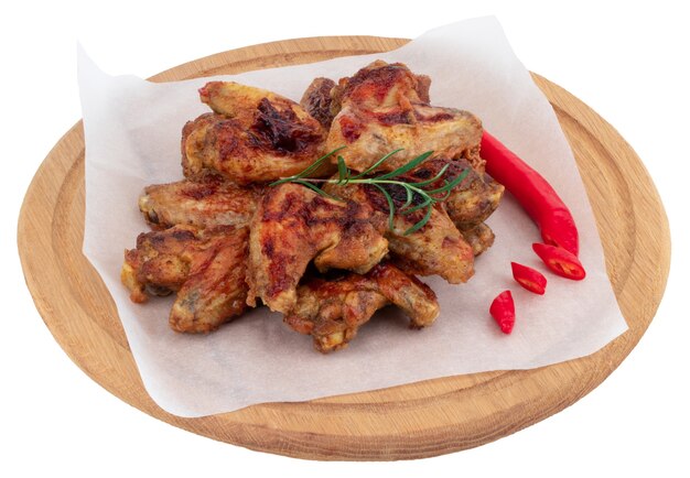 Grilled chicken wings on wooden cutting board isolated