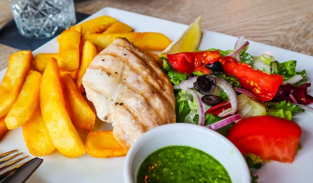 Grilled chicken with french fries and vegetables