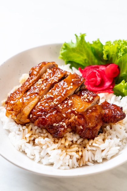 grilled chicken with teriyaki sauce on topped rice bowl