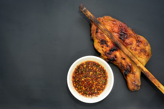 grilled chicken with Thai style dipping spicy sauce, street food