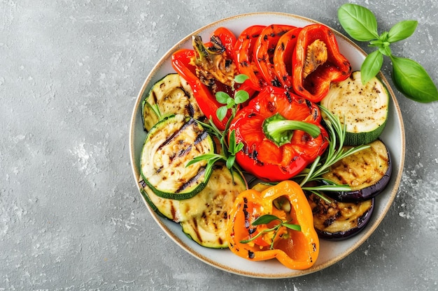 Grilled colorful vegetables on plate over grey background