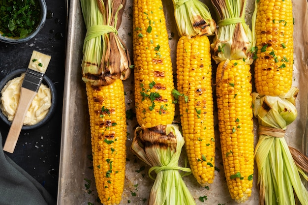 Grilled corn on a baking sheet, top view, close-up