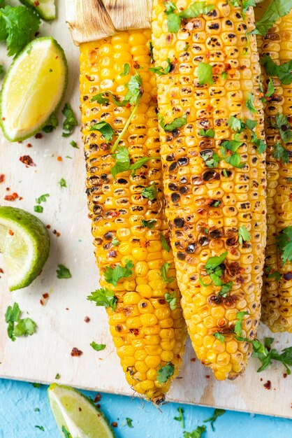 Grilled corn cob in husk with coriander lime salt and garlic sauce mexican street food