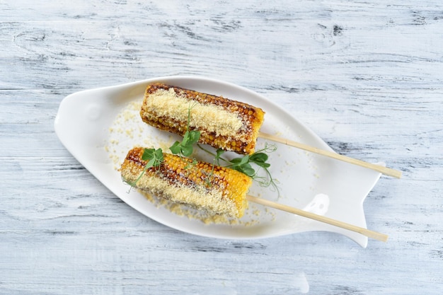 Grilled corn on the cob with parmesan cheese, grilled corn, grilled vegetables