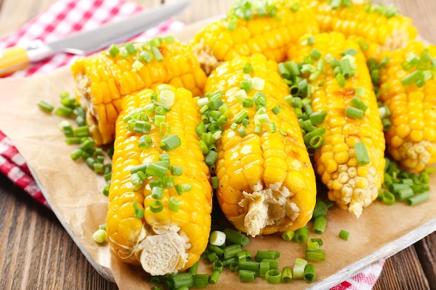 Grilled corn cobs on table closeup