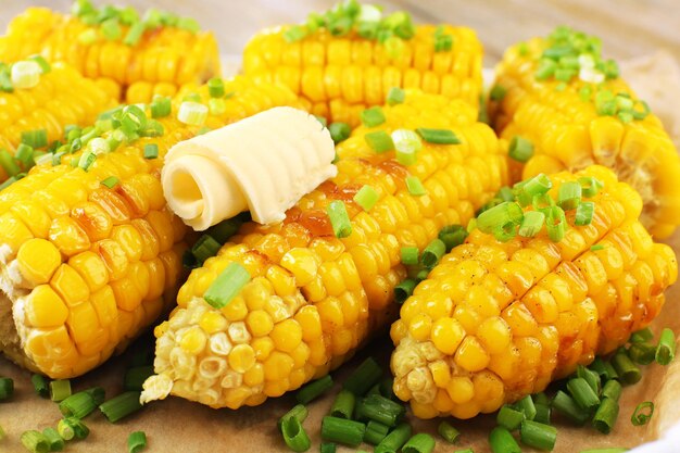 Grilled corn cobs on table closeup